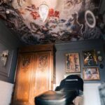 This image showcases the Vatican Lounge tattoo shop in Manchester, UK. It provides a detailed view of the shop's interior, including its layout, design, and ambiance, giving a glimpse into the environment where tattooing services are offered.