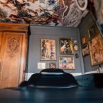 This image features the Vatican Lounge tattoo studio in Manchester, UK. It presents an overview of the studio's exterior, including its signage and entrance, offering a view of the location where clients can receive their tattoos.