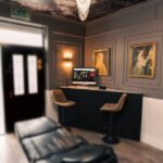 This image showcases the interior of the Vatican Lounge tattoo studio located in Manchester, UK. It highlights the studio's layout, décor, and ambiance, providing a glimpse into the environment where tattoos are created.